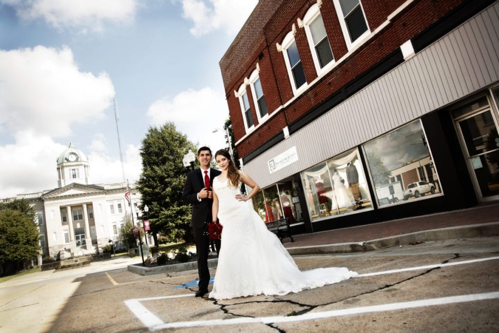 Bride and groom standing outside the original Andrew Jackson Bridal in Jackson, MO