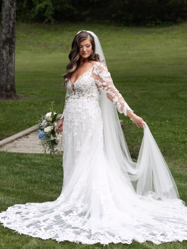 bride wearing a long sleeve wedding dress from AJ Bridal Company, a bridal shop in Cape Girardeau